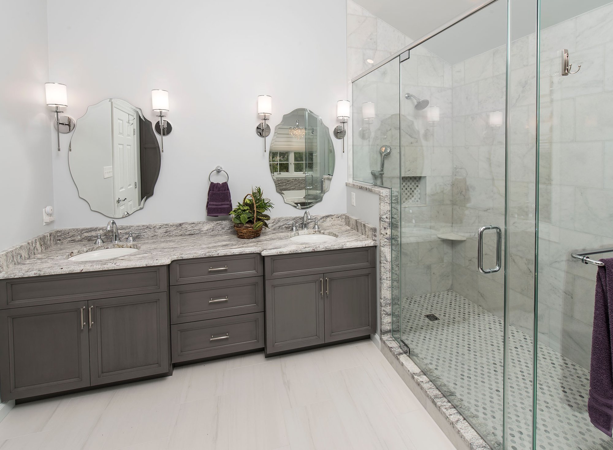 bathroom with double sinks and shower